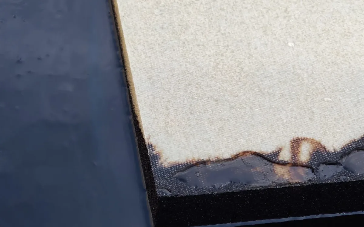 Edge of a FoamFlex pad with absorbed oil showing along the side